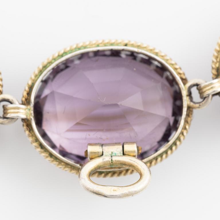 Garniture, necklace and bracelet silver with amethysts, brooch gold-coloured metal with purple paste stones,