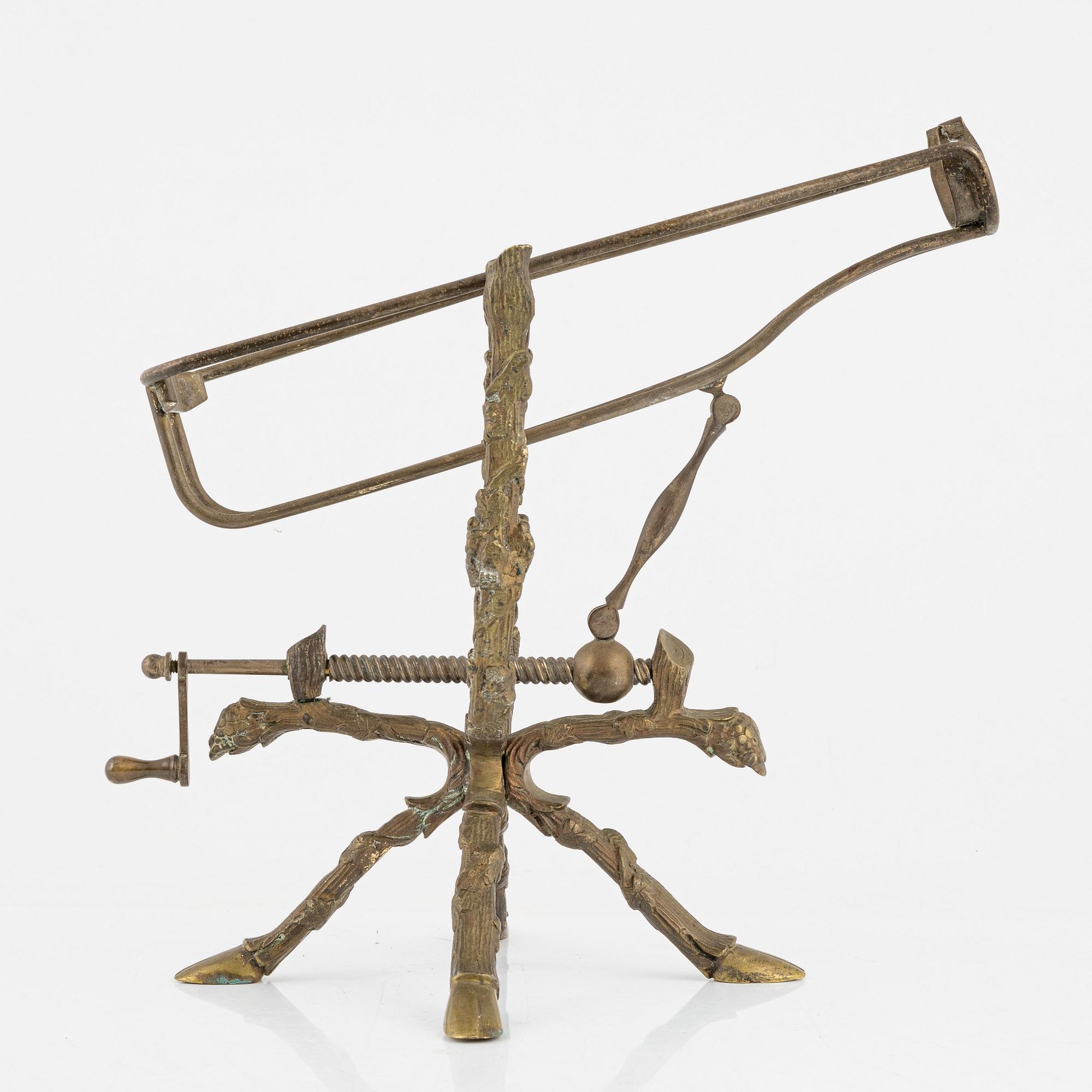 A brass bottle holder, circa 1900.