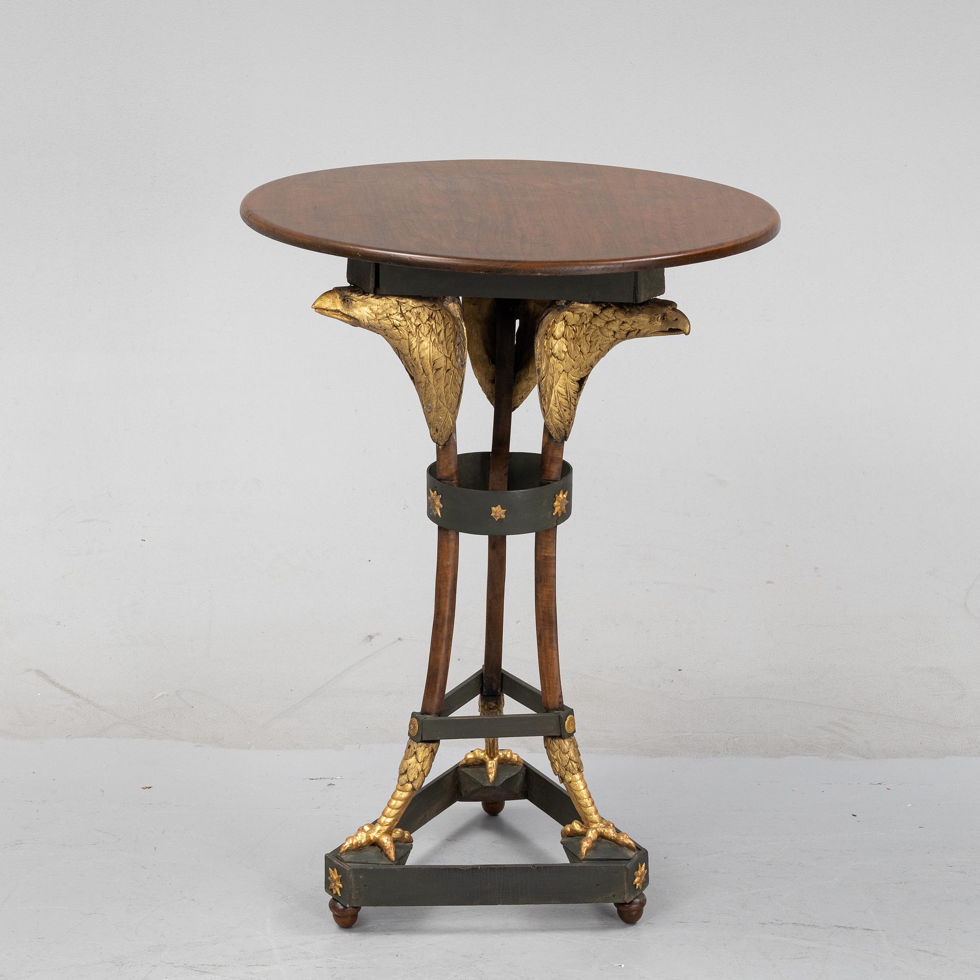 A presumably Russian giltwood and walnut Empire table, early 19th Century.