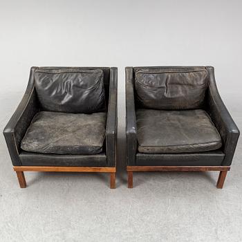 A pair of "The President" black leather armchairs by Ingemar Thillmark for OPE-möbler, Sweden.