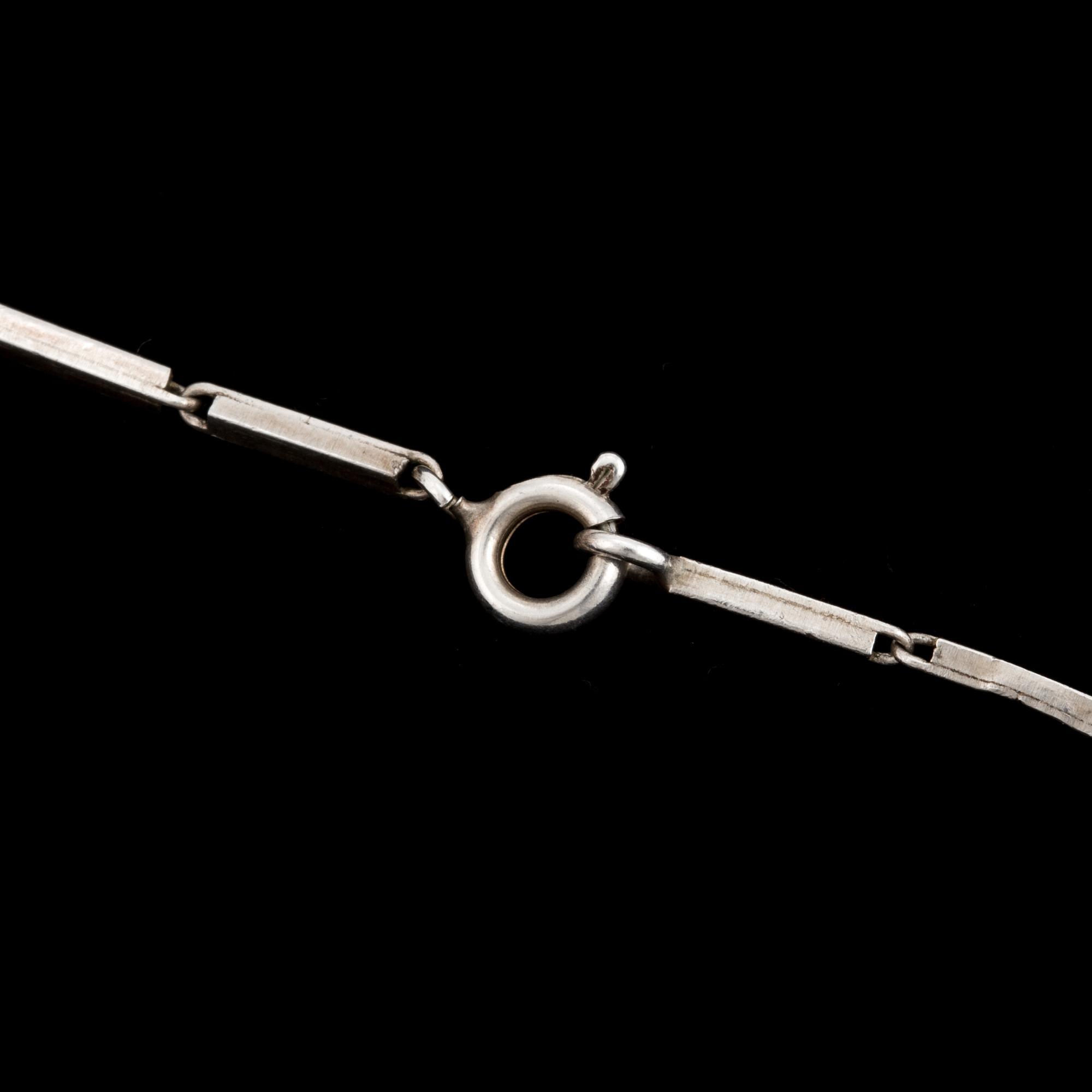 A glass pendant designed by Gunnar Cyrén and a silver necklace.