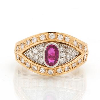 An 18K gold and platinum ring with diamonds and a ruby.