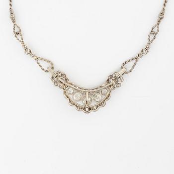 A brooch/necklace combination in 18K white gold set with old- and eight-cut diamonds.