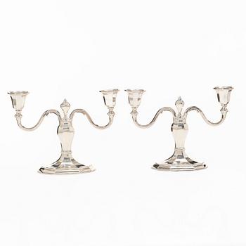 A pair of silver candelabras, with Swedish import marks, possibly mid20th century.