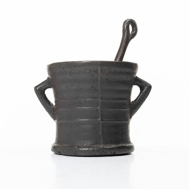 Mortar and pestle, dated 1673.