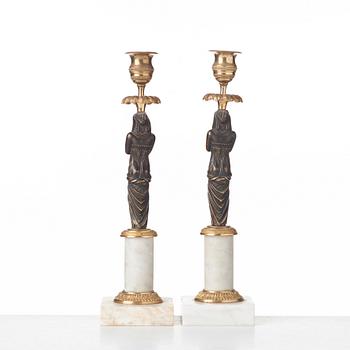 A pair of late Gustavian circa 1800 white marble and bronze candlesticks.