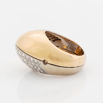 A Paul Binder ring in 18K gold set with round brilliant-cut diamonds.
