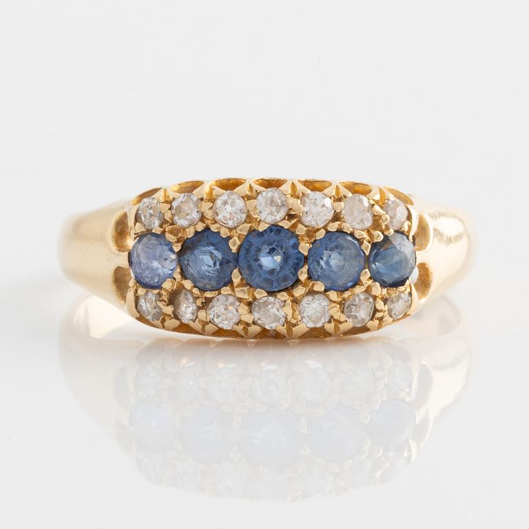 Ring in 18K gold with diamonds and blue stones.