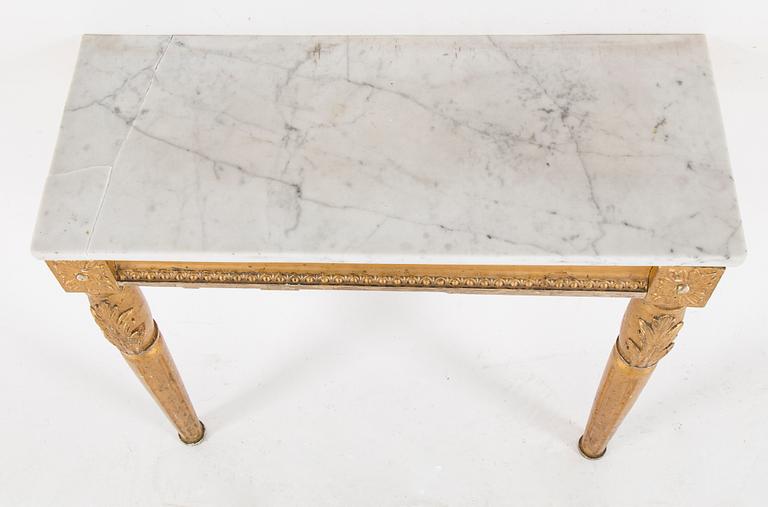A Swedish Gustavian style mirror and console table with marble top from the first half of the 20th century.