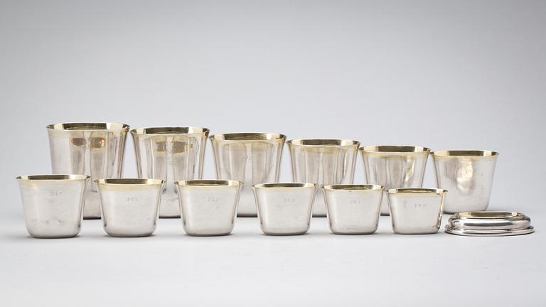 A set of 12 Swedish early 18th century parcel-gilt hunting-beakers and cover, marks of Petter Henning, Stockholm 1707.