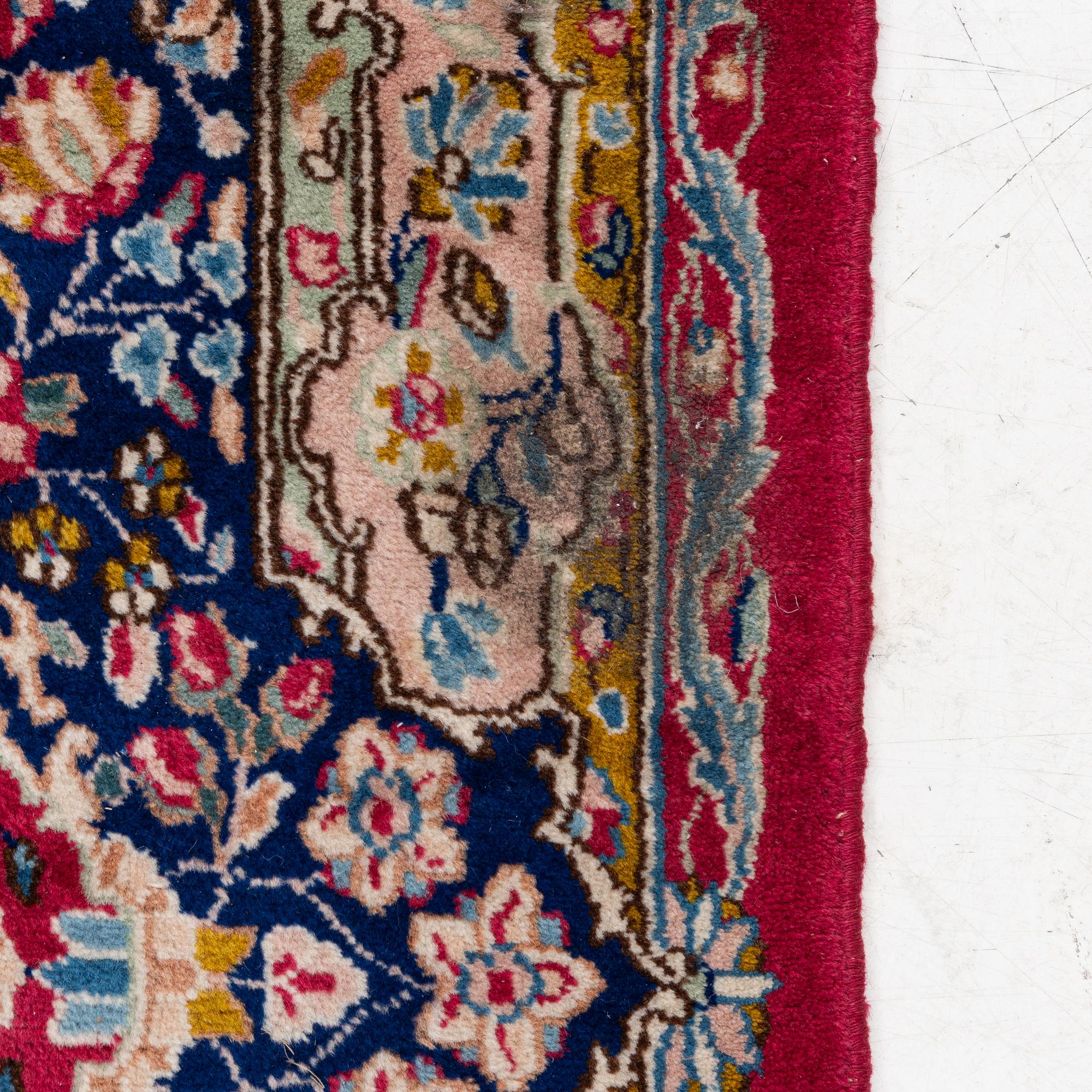 A Kirman carpet, signed, c. 388 x 279 cm.