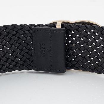 Gucci, a leather belt.