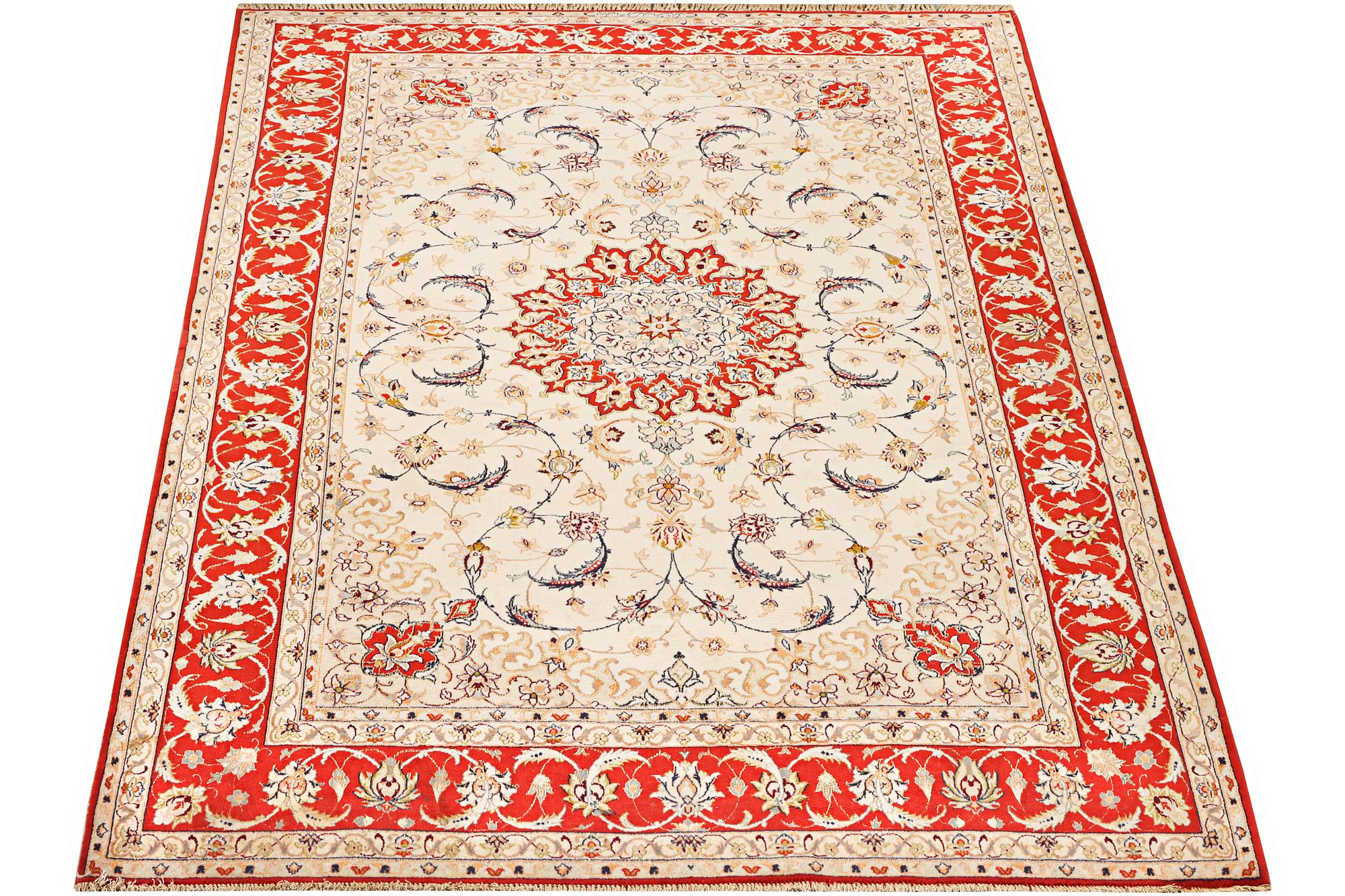 A semi-antique part silk Isfahan rug, a. 238 x 156 cm.