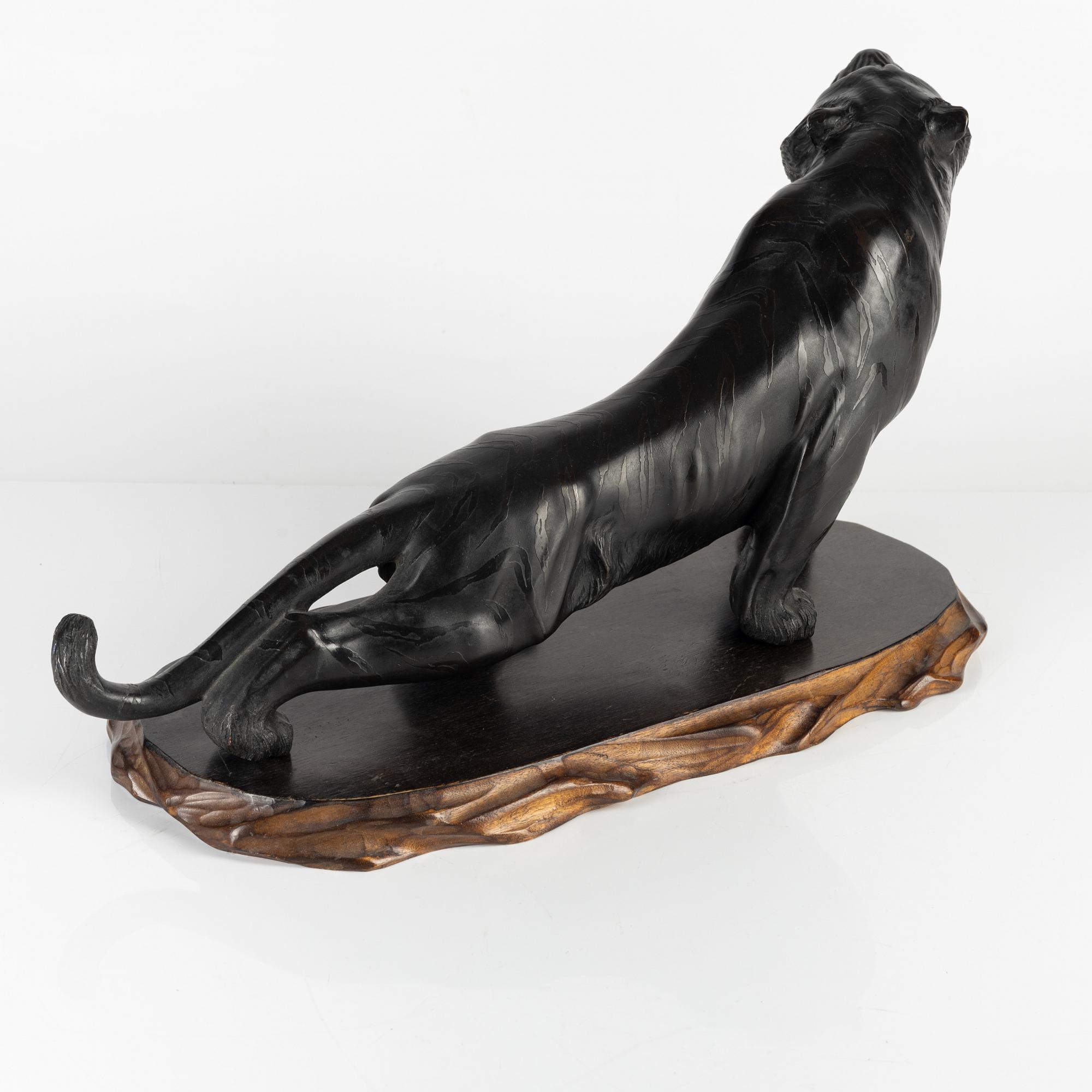 A Japanese bronze sculpture of a tiger, 20th Century.