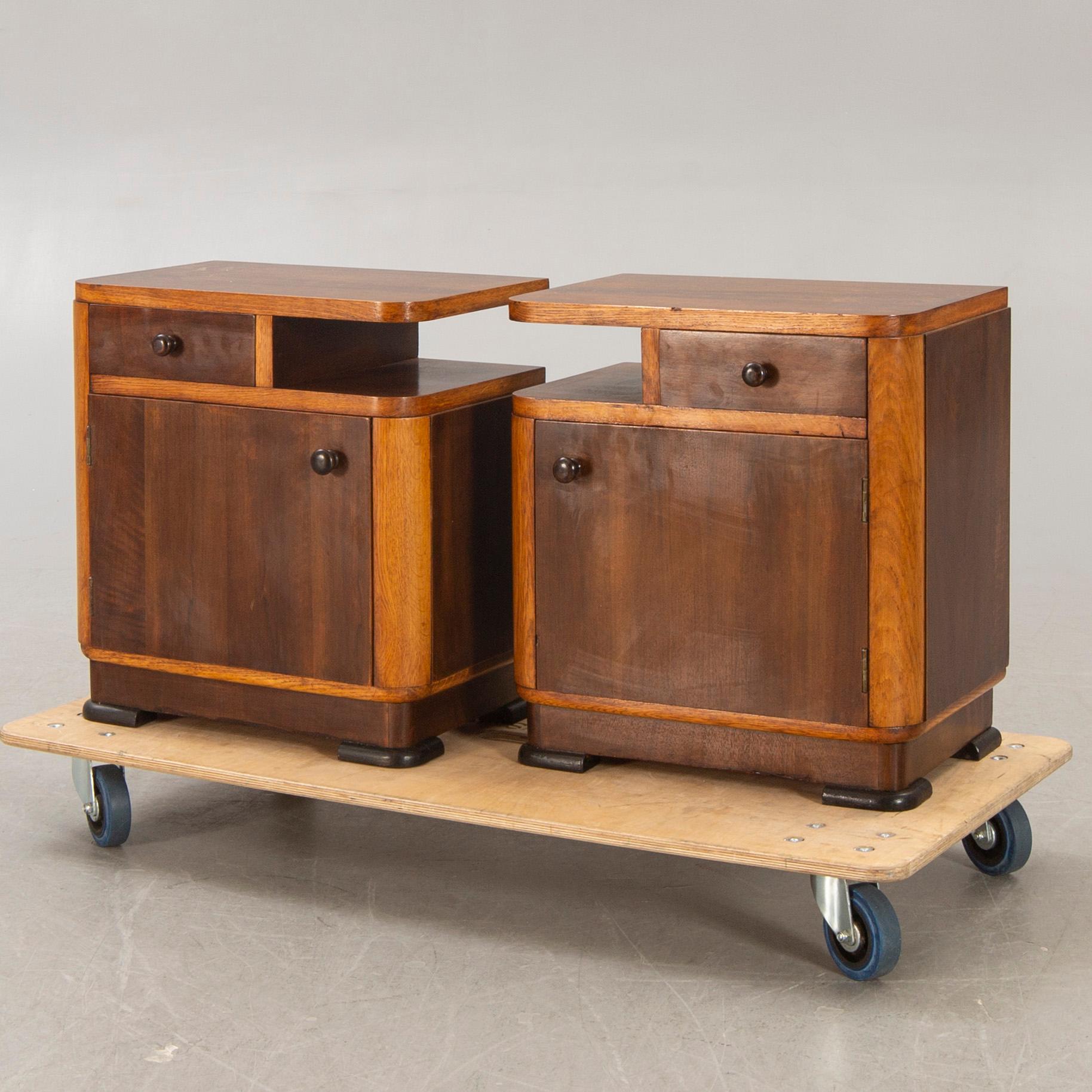 A pair of walnut/mahogany bedside tables first half of the 20th century.