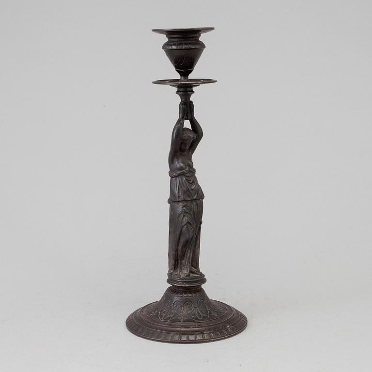 A 19th century iron candlestick marked F.L Vombach Offenbach A/M.