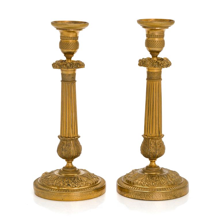 A pair of Empire ormolu brass candlesticks, France early 19th century.