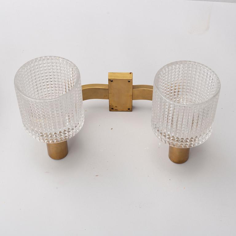 A pair of the 20th century brass and glass wall lights.