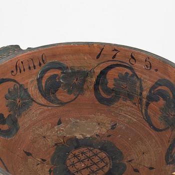A lathed and painted bowl dated 1783.