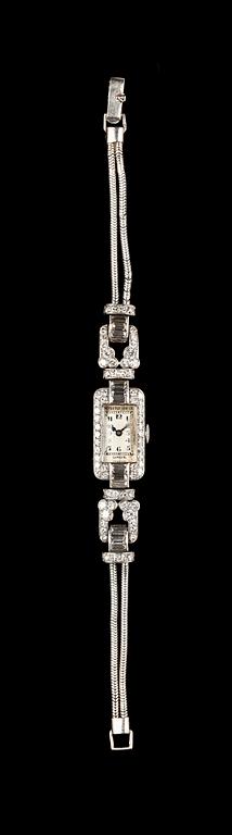 A Patek Philippe ladie's wrist watch, set with baguette- and brilliant cut diamonds, tot. app. 4 cts.