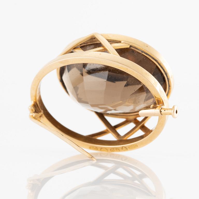 Brosch 18K guld med en fasettslipad rökkvarts.