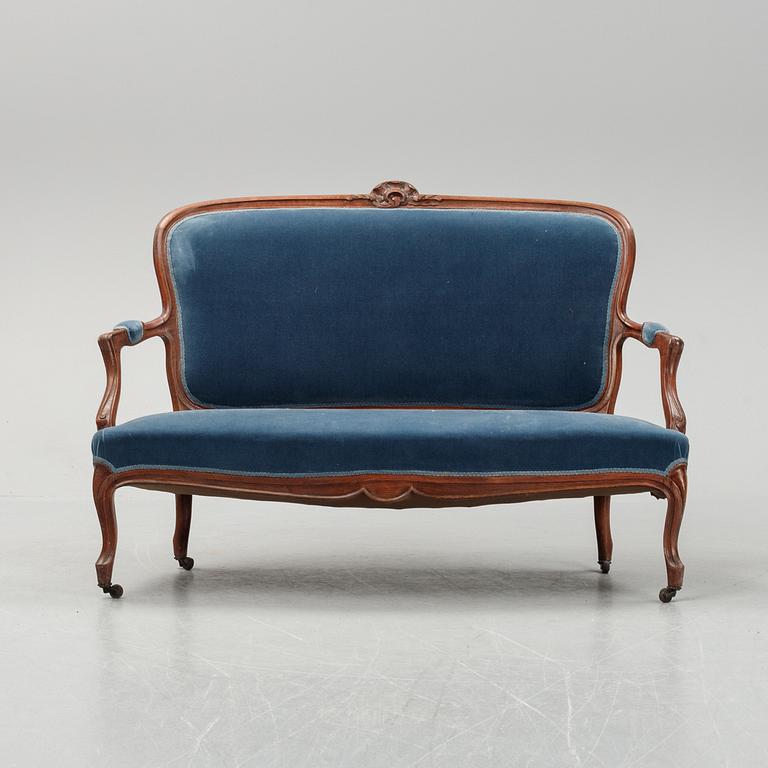 A sofa and a set of four chairs, Rococo revival, late 19th century.