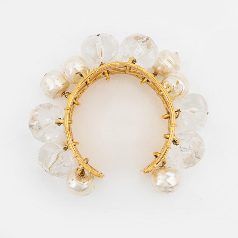 Céline, a gold tone bracelet.