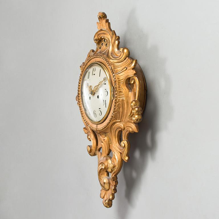 A Rococo style wall clock from first half of the 20th century.