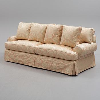 A sofa upholstered with silk damask.