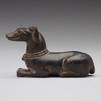 A bronze figure of a reclining dog, Ming dynasty (1368-1644).