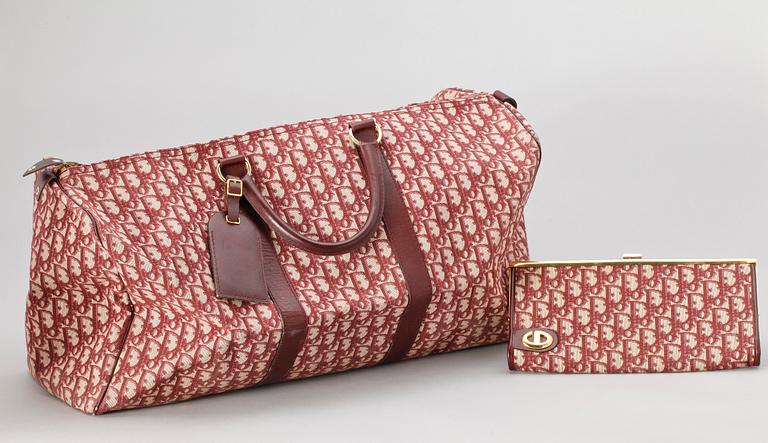 A red monogram canvas weekendbag and clutch by Christian Dior.