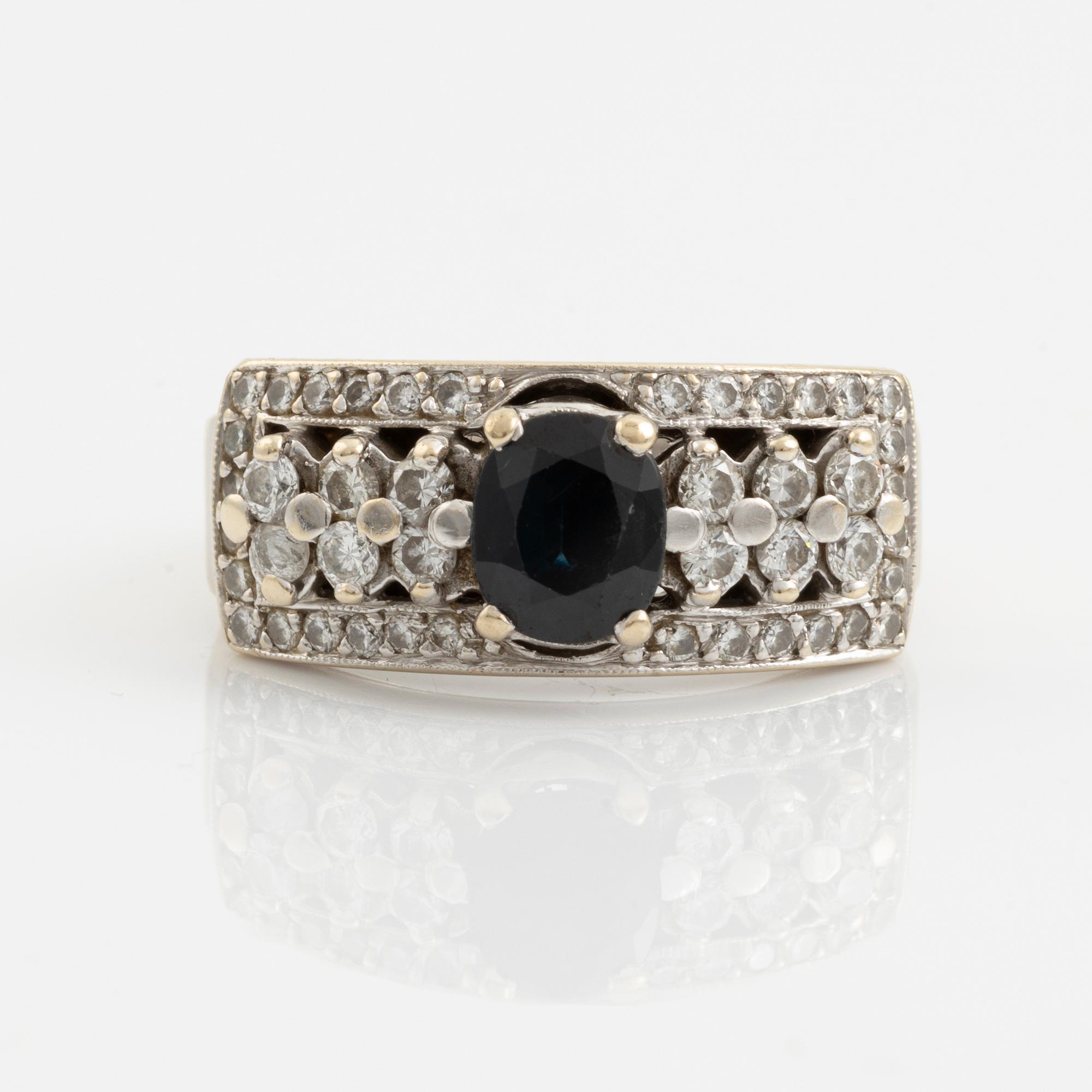 Ring with dark sapphire and brilliant-cut diamonds.