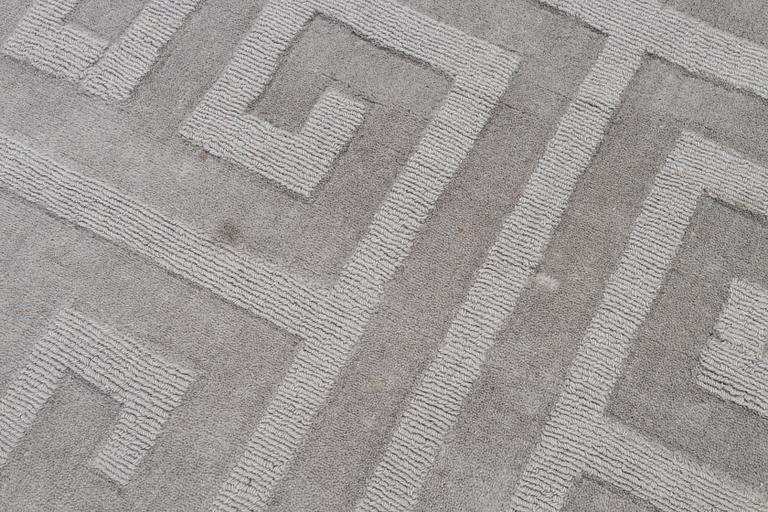 A 'Cubes' carpet, Layered, c. 270 x 180 cm.