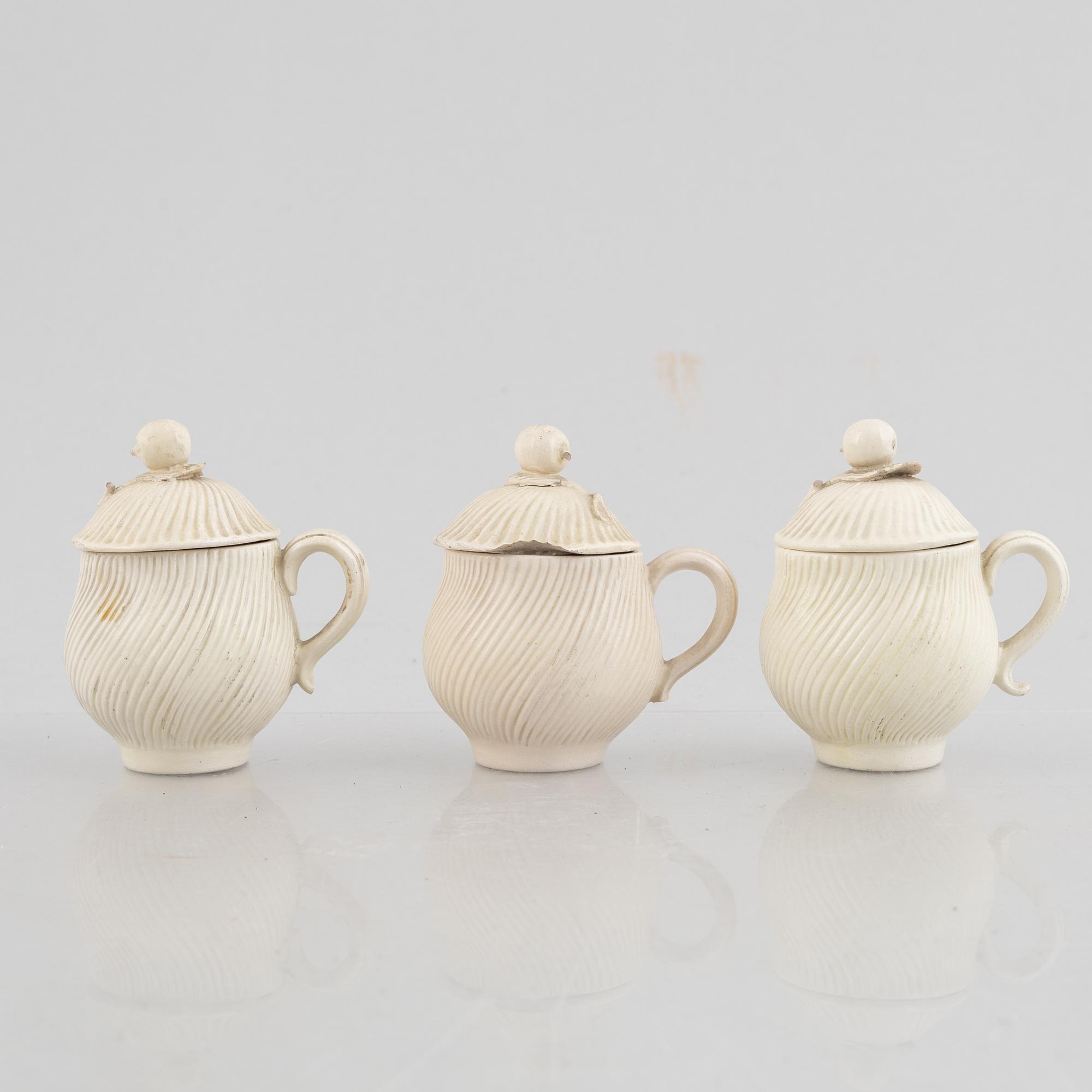 A set of six soft-paste porcelain custard cups with covers, 18th century.