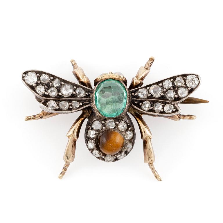 A brooch in silver and 14K gold with coloured gemstones and rose-cut diamonds.