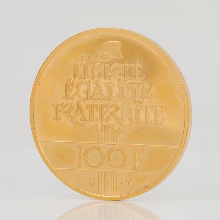 GULDMYNT. 100 Francs, 1986. Vikt ca 17 g.