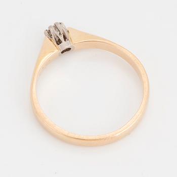 A round brilliant-cut diamond ring.