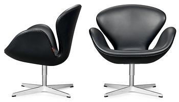 A pair of Arne Jacobsen dark grey leather "Swan" easy chairs, Fritz Hansen, Denmark 2008.