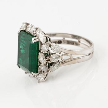 An 18K white gold ring set with a step-cut emerald.