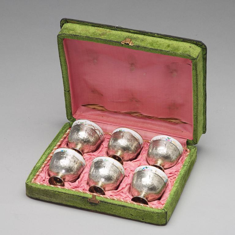 A set of six Ottoman parcel-gilt silver Xarfs with Russian Kuznetzov porcelain cups, c. 1910.