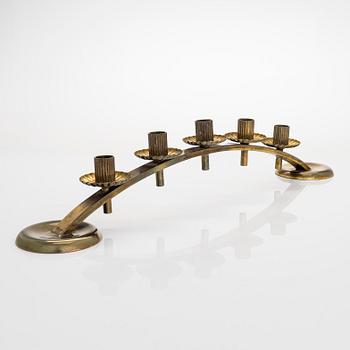 A mid-20th century brass candle holder, Idman.