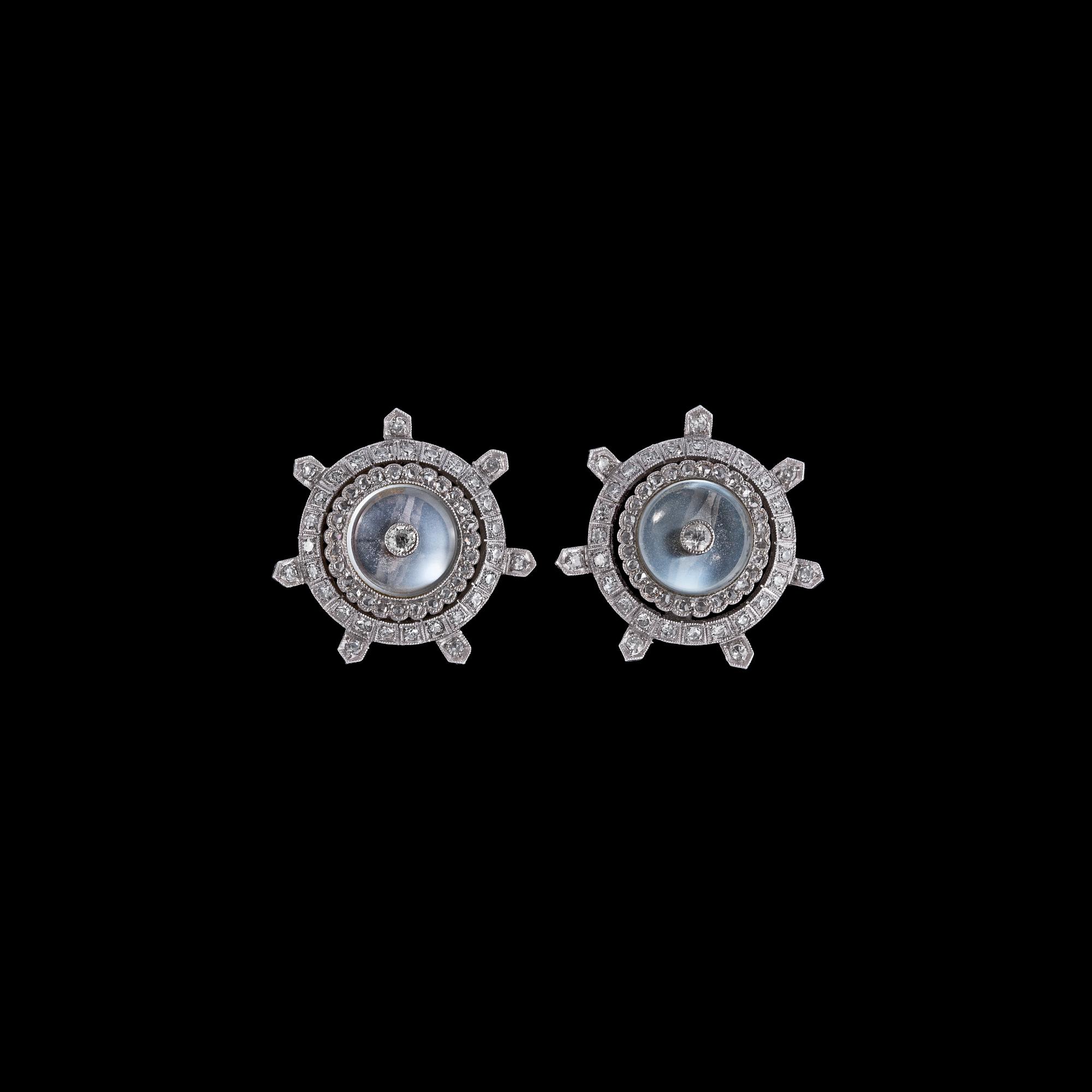 A pair od moon stone and diamond earclips.