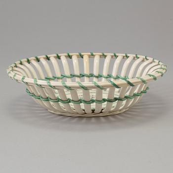 A CREAMWARE BASKET, PLATE AND A SIMILAR PLATE, one marked Wedgwood, first half of the 19th century.