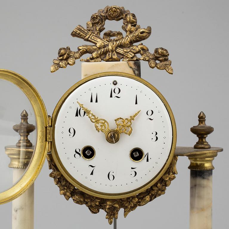 A marble and brass pendulum clock, first half of the 20th century.