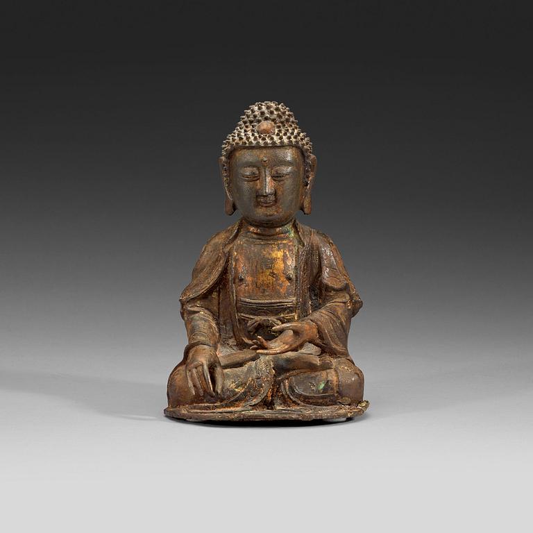 A bronze figure of a seated Buddha, late Ming dynasty (1368-1644).