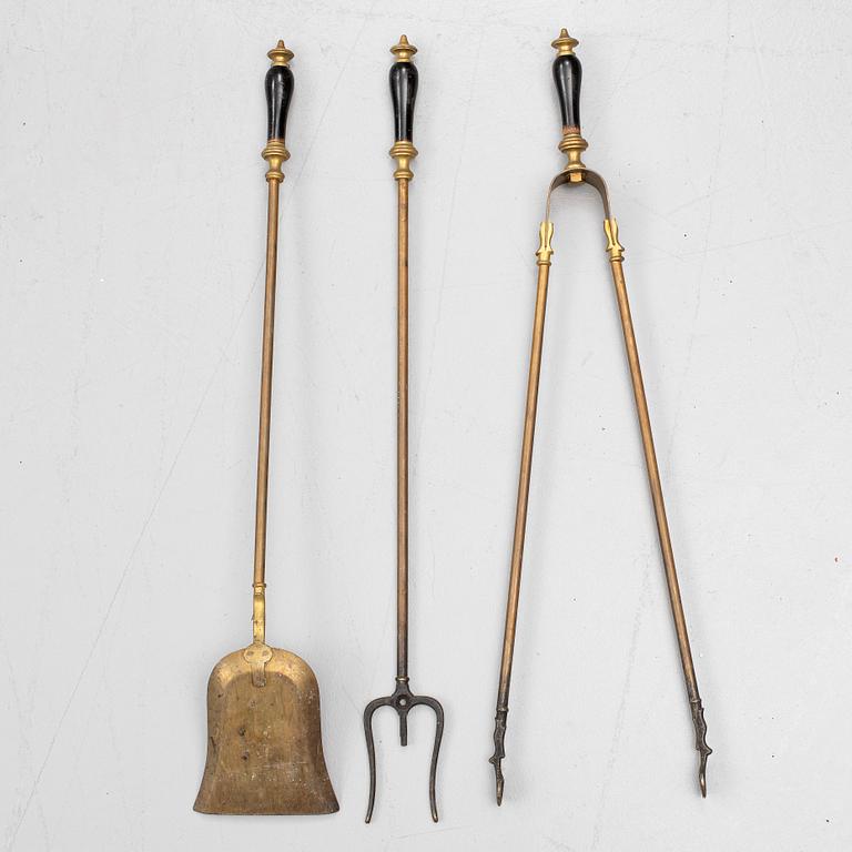 A set of three brass fire irons, 19th century.