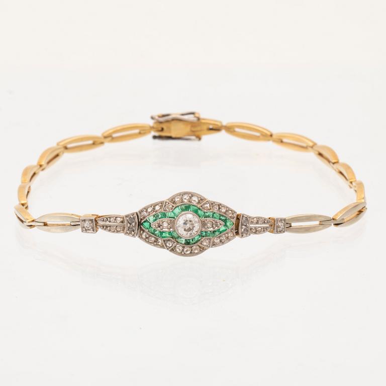 An 18K white and red gold bracelet set with emeralds between rose cut and old cut diamonds.