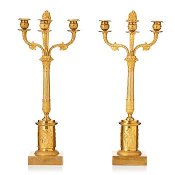 145. A pair of Empire ormolu three-light candelabra, Stockholm, early 19th century.