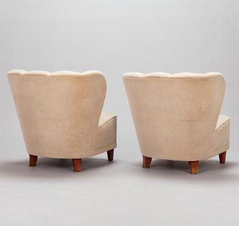 A pair of mid-20th century armchairs.
