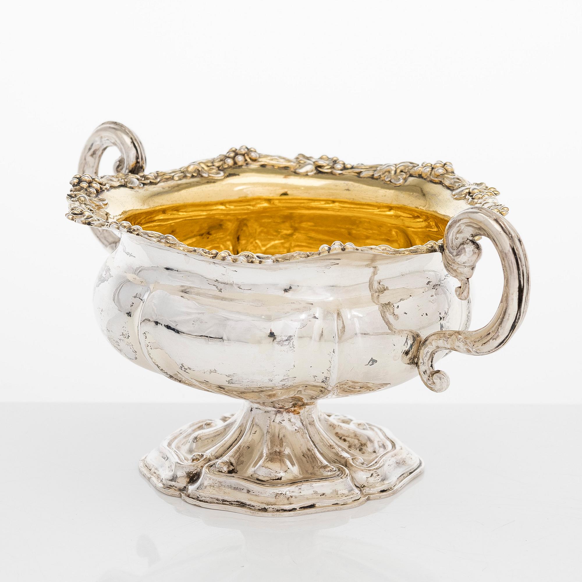 A silver sugar bowl, R. Mellin, Helsinki 1860, and two tea strainers, Kuopio and Porvoo, first half of the 19th century.